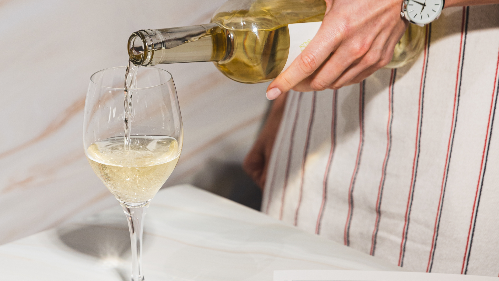 Why shouldn't you pour wine with your left hand?