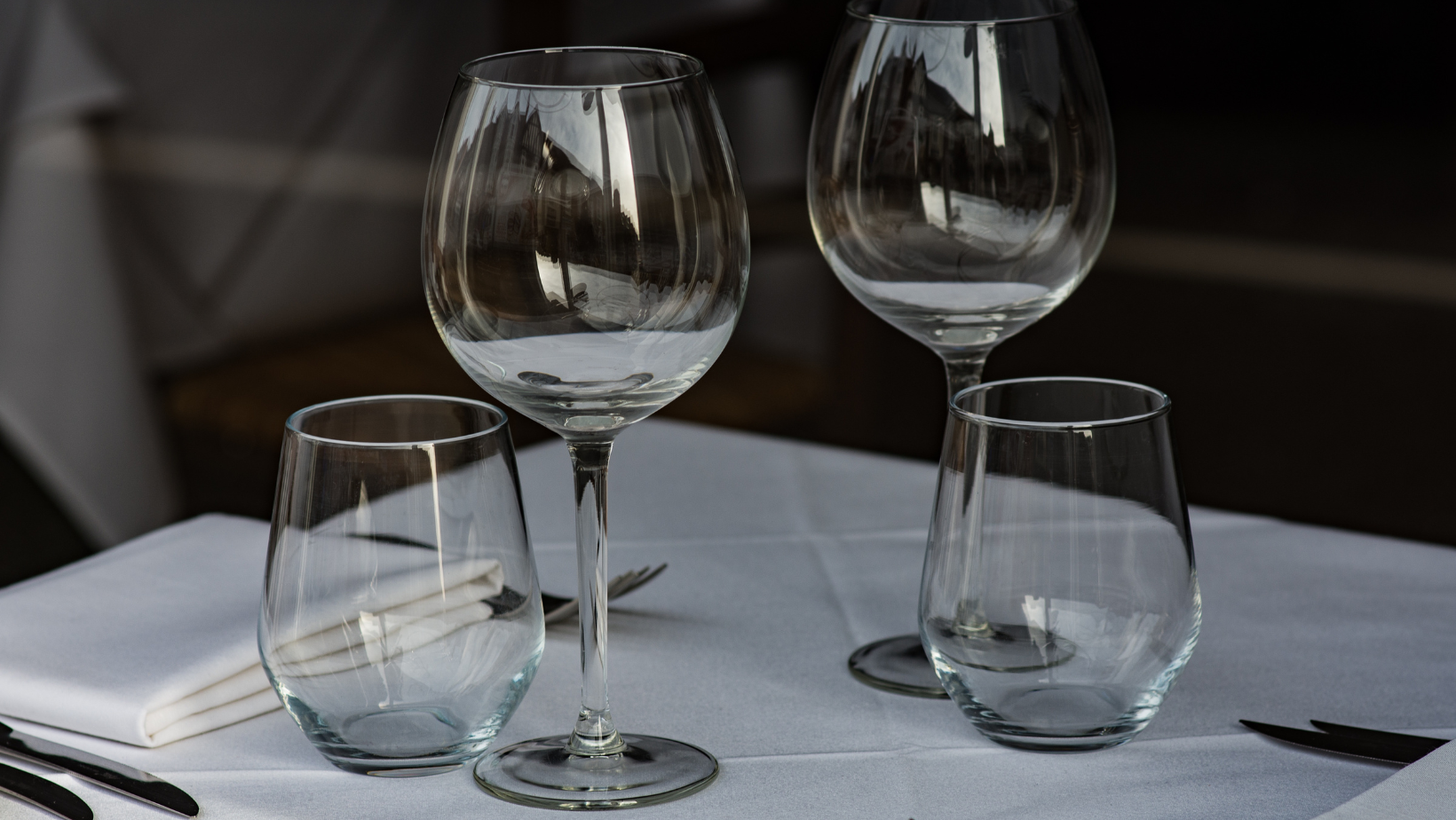 Should wine glasses be stored and served facing up or down?